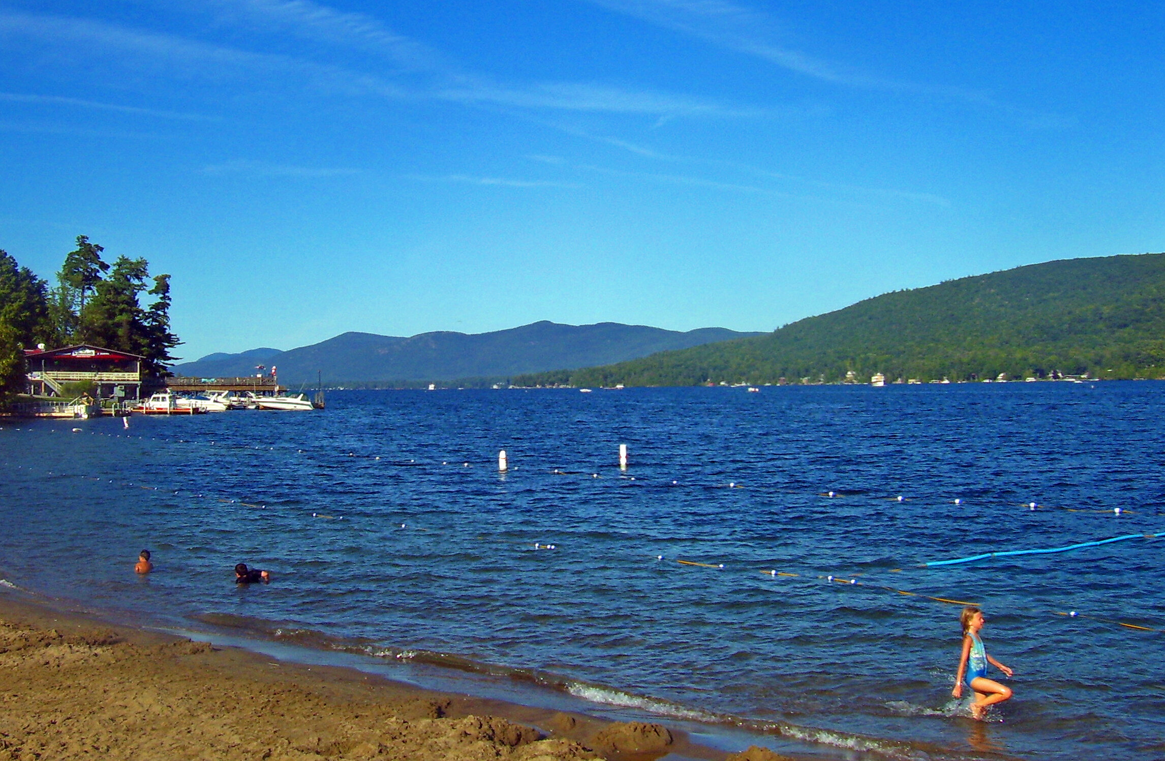 Lake George summer beach with boats and the basin beyond