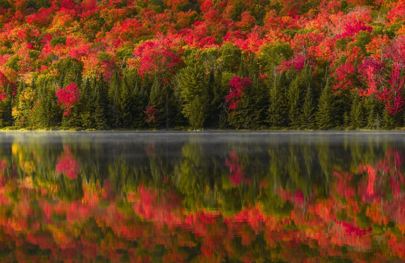 Red foliage reflected in a still Adirondack lake